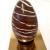 Chocolade paasei met streepjes 
Mogelijk in melk of pure chocolade
 - Ongevuld +/- 220gr : € 10
 - Gevuld met kleine gevulde eitjes +/- 500gr :                     € 22
